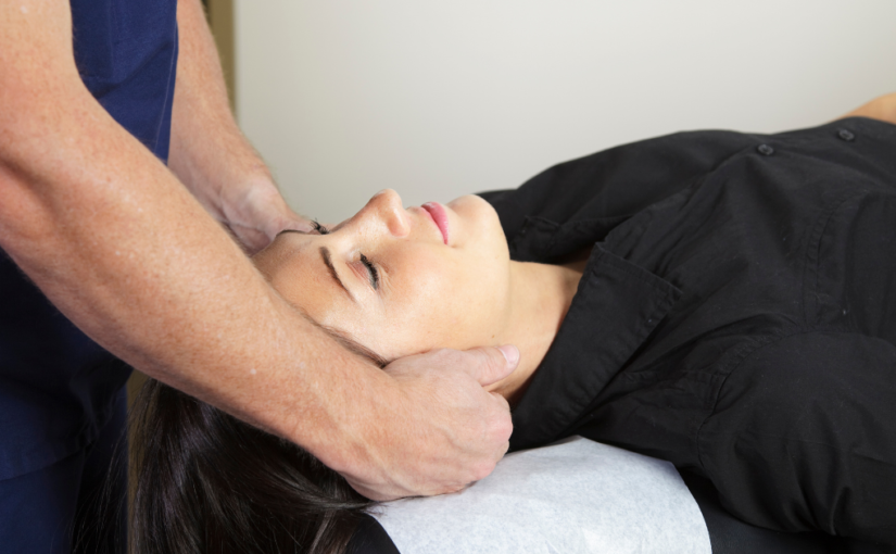 Chiropractor adjusting patient neck